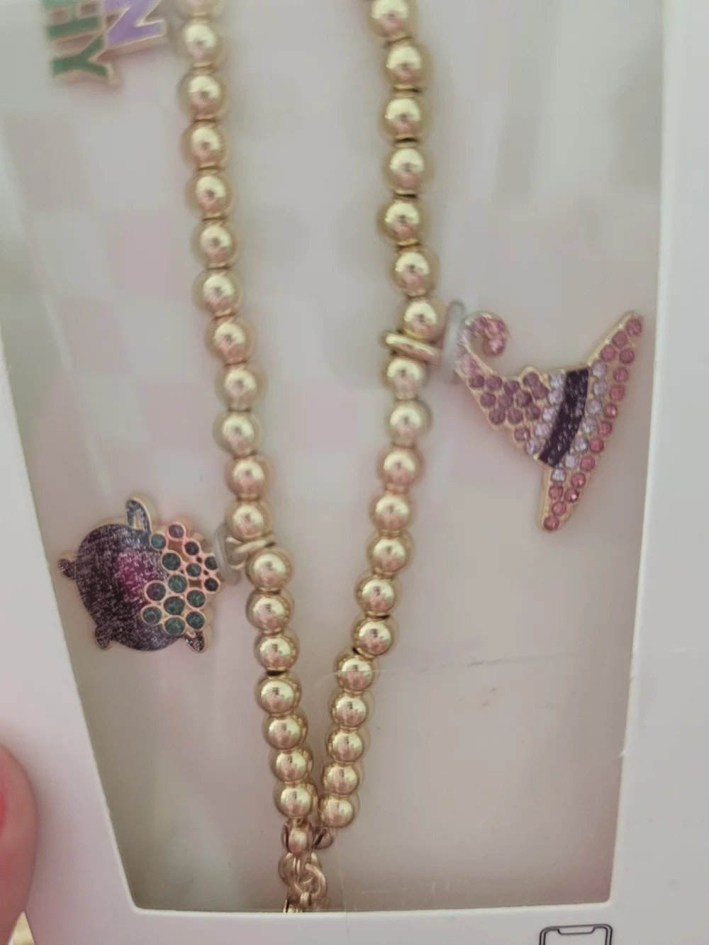 BaubleBar Gold Beaded Phone Charm Wristlet with Enamel Accents